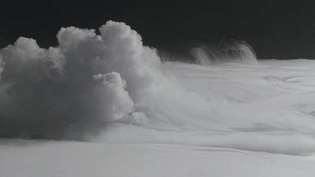 Dense white smoke clouds billowing and rolling across dark background surface