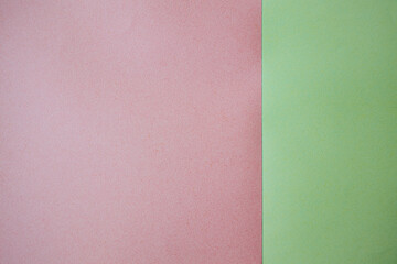 Pink and green textured paper sheets arranged side by side, showcasing a smooth surface with subtle variations in color and texture for creative projects © Emvats