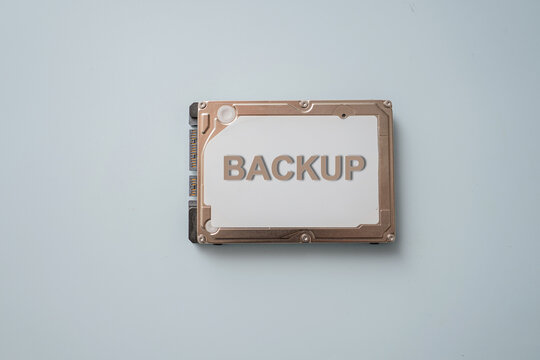 Hard drive labeled as backup on a light surface