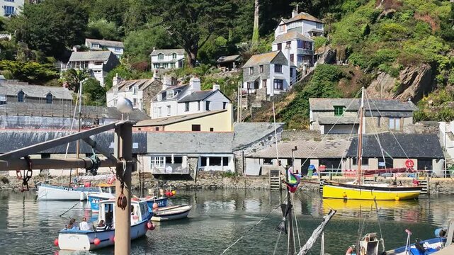 Polperro Cornwall England UK. 13.08.2026. Video. Tourists aboard  boat in Polperro Harbour taking a boat trip around the harbour and out to sea.