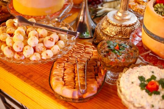 Snacks table with cheese bread sliced cold cuts and various delicious accompaniments