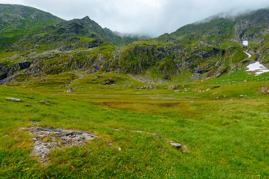 Romania mountain landscape in summer. scenic view of Fagaras ridge under overcast sky. rainy weather forecast background
