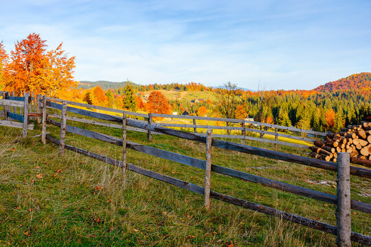 Romania countryside on autumn evening. mountain scenery with wooden fence through hill. rural life in remote area of Apuseni natural park