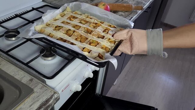 Putting a Homemade Apple Pie into the Oven for Baking