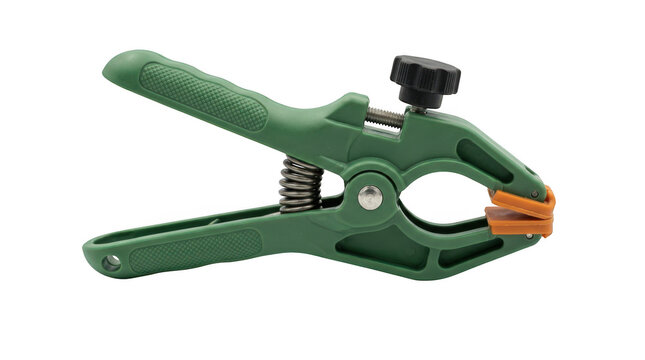 Green plastic spring clamp with adjustable screw handle isolated on transparent background
