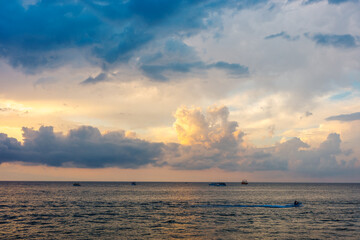 Obraz premium Ocean sunset, dramatic storm clouds, seascape, summer travel, marine recreation, boating, changing weather, scenic coastal background.