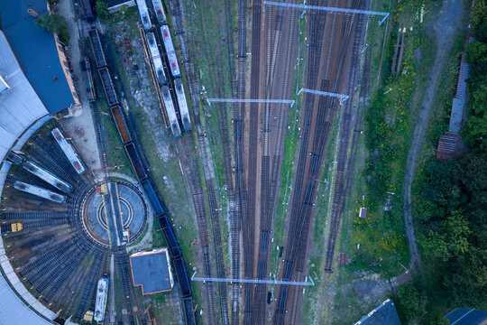Aerial view of railway depot with turntable, multiple tracks, and parked trains