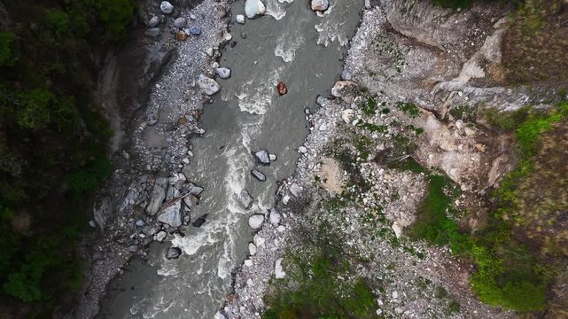 Rasuwagadhi, Rasuwa, Nepal - 29 August 2026: Aerial view of the Trishuli River flowing through rocky banks and lush green vegetation.