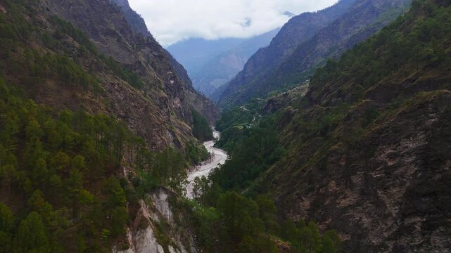 Rasuwagadhi, Nepal - 29 August 2026: Aerial view of the Trishuli River flowing through a deep mountain valley with steep forested slopes and rocky cliffs.