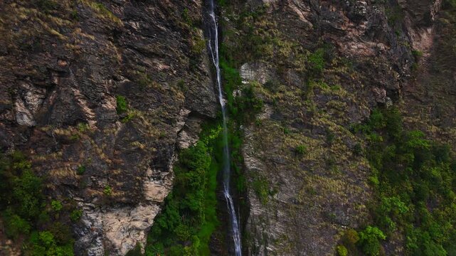 Langtang, Rasuwa, Nepal - 29 August 2026: Aerial view of the Trishuli waterfall cascading down a steep rocky cliffside surrounded by lush green vegetation in langtang, national park, Nepal
