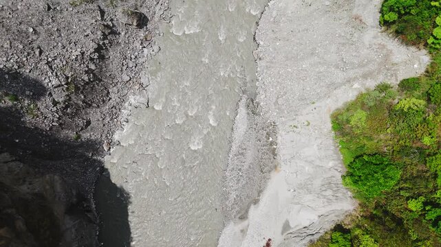 Rasuwagadhi, Nepal - 29 August 2026: Aerial view of Trishuli river flowing through a rocky gorge with lush green vegetation and gravel banks.