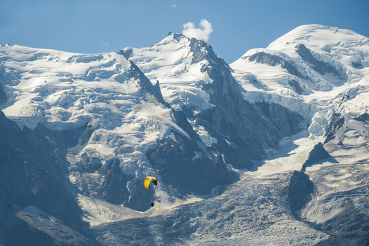 Paraglider Flying In Front Of Mont Blanc Peak 4810m With Glaciers Shot From Brevent High Altitude Extreme Sports Alpine Adventure In French Alps Chamonix Scenic Mountain View Paragliding Experience