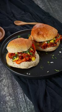 Delicious al pastor cemita served with Mexican sauces and pickled vegetables