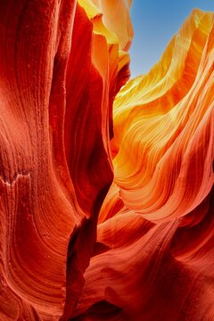 Slot Canyon, Sandstone, Sunlit, Red Orange Layers, Blue Sky.