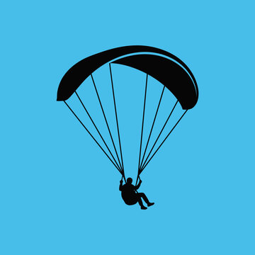 Silhouette Of A Person Paragliding Against A Vibrant Blue Sky
