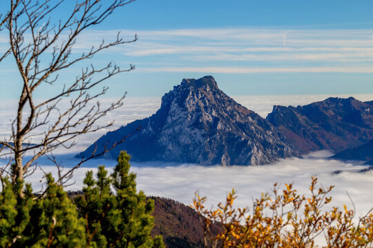 Traunstein mountain rising above autumn inversion over Lake Traunsee, Austria
