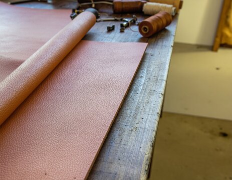 Leatherworking Workspace with Rolled Leather and Craft Tools