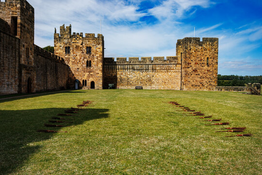 Medieval castle fortress with stone walls and towers on grass