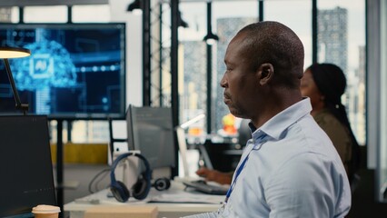 Fototapeta premium Software developers in a startup office use artificial intelligence and deep learning to drive market innovation, optimize operations and improve efficiency through collaborative technical work.
