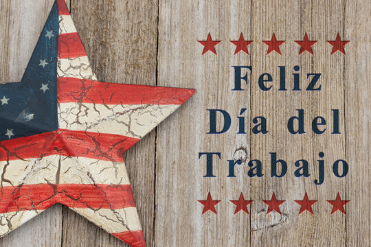 Feliz D&iacute;a del Trabajo text with retro USA red and blue star on weathered wood for Happy Labor Day