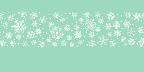 Fototapeta premium Light mint green Christmas background with delicate white snowflake illustrations creating a festive winter scene.