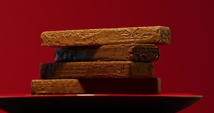 Chocolate waffles on a red plate and a red background. Сonfection, sweets and candies. Tasty and delicious food.