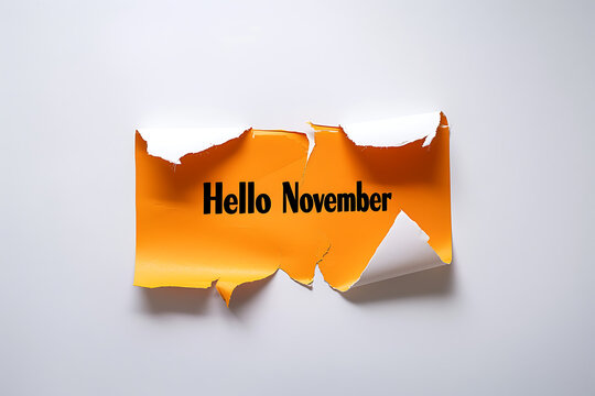 Torn orange paper revealing Hello November text on white background for autumn greeting
