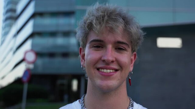 Young urban influencer smiling standing confidently in front of a sleek modern building, radiating happiness and trendy vibes