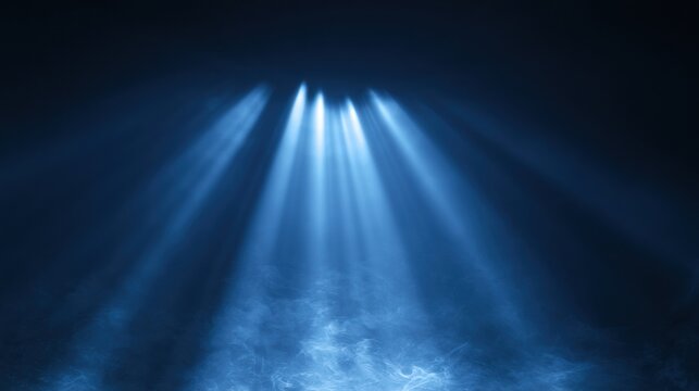 Blue light rays cut through a haze creating a unique atmosphere that allows for space to add text or other visual elements.