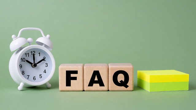 Minimalist FAQ concept with alarm clock and wooden blocks on green background