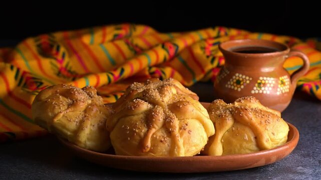Traditional Mexican pan de muerto with sesame seeds and clay coffee cup