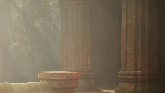 Sunlight filters through the trees and illuminates old stone pillars in a temple. The time is early morning, creating a soft glow in the environment.