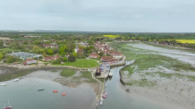 Fields and Farms over Bosham Quay from a drone at low tide, Chichester Harbour National Landscape, Chichester, West Sussex, England