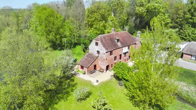 White Mill and Old Bridge over River Stour from a drone, Sturminster Marshall, Dorset, England