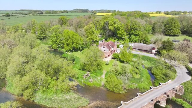 White Mill and Old Bridge over River Stour from a drone, Sturminster Marshall, Dorset, England