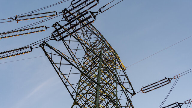Energy grid infrastructure with high voltage pylons.