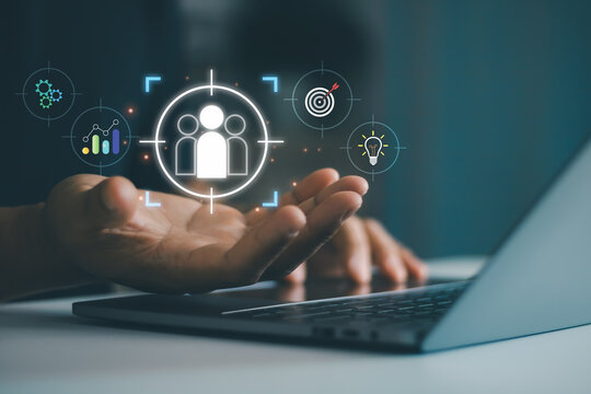 Businessman hand holding digital target audience icon, symbolizing customer focus, market analysis, audience segmentation, business strategy and data driven decision making in corporate, start up.