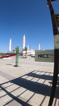 Traditional outdoor majlis seating area with a beautiful view of Masjid Quba in Medina.