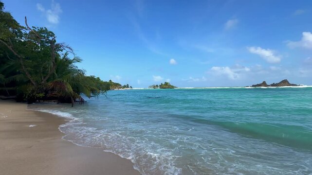 San Andr&eacute;s beach with exposed coral formations &mdash; 20 seconds Tropical Beach in San Andr&eacute;s Colombia with Exposed Coral Rock Formations, Turquoise Caribbean Water and Distant Cayo Acuario and Haynes Cay,