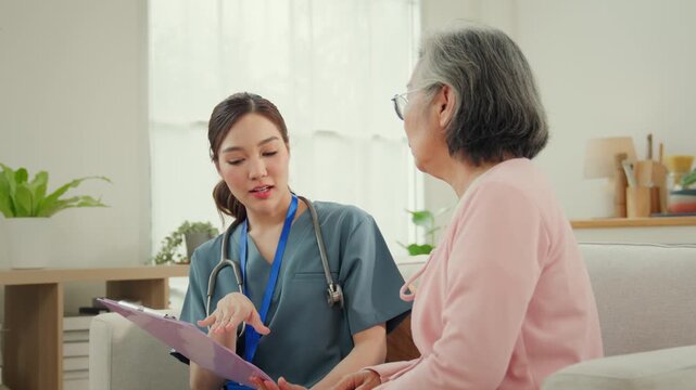 Elderly home care caregiver nursing support bright living room with nurse and senior woman discussing health plan elderly caregiver home nursing care with nurse consulting senior woman bright living