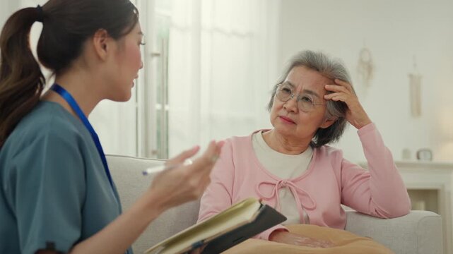 Elderly caregiver nursing home care support for senior woman in warm living room with gentle conversation and attentive medical help