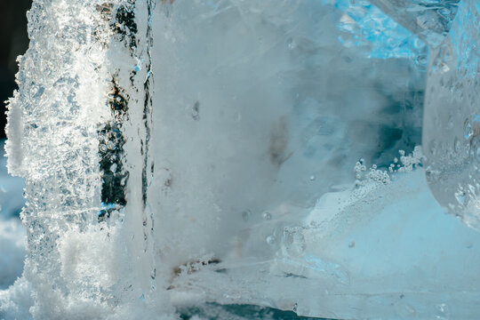  piece of ice. close-up of translucent blue ice with frozen bubbles and crystalline patterns for climate change,seasonal design,frozen water themes,purity branding,wellness visuals.frozen texture