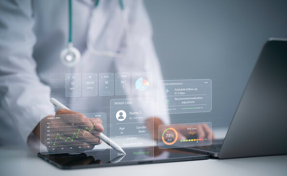 Doctor using laptop with AI patient monitoring interface showing vital signs medical data risk analysis digital healthcare technology clinical decision support and remote patient care system