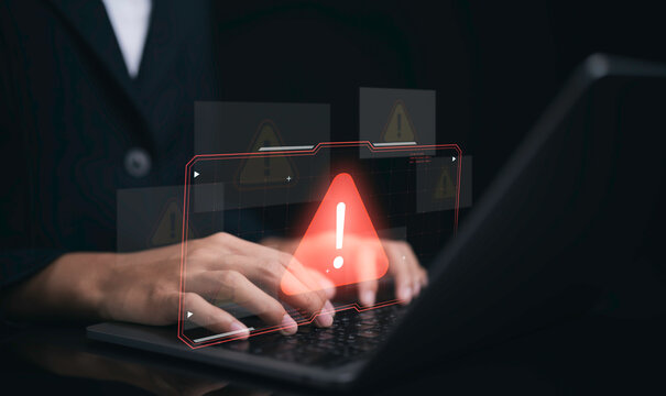 Cybersecurity warning on laptop screen showing red alert symbol for digital security threat risk protection data breach malware privacy network safety and information security