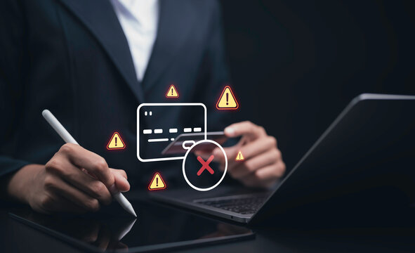 Business professional uses tablet and laptop with failed transaction alert showing payment error warning digital security risk fraud prevention online banking and financial protection