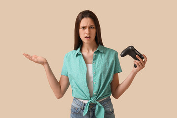 Gaming frustration and video game loss, confused young woman holding a controller with an annoyed expression on a plain studio background © Pixel-Shot