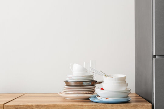 Household chores and domestic burden, stack of dirty dishes and messy plates on a kitchen counter with copy space for home maintenance concepts