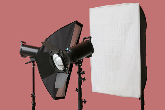 Photography lighting equipment, professional studio production and creative media industry tools with softbox and strobe light on a pink background