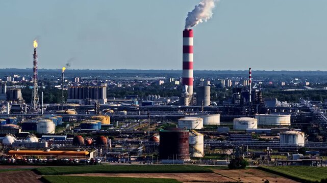Aerial view of the Orlen Plock Production Plant with industrial chimneys, storage tanks, and pipelines in Plock, Mazowieckie, Poland.
