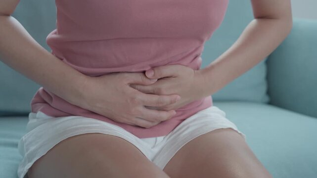 stomach ache. Asian women have abdominal pain, indigestion, gastritis, menstrual cramps, flatulence, diarrhea, distention, colon cancer, belly inflammation problem, suffer food poisoning, abdomen
